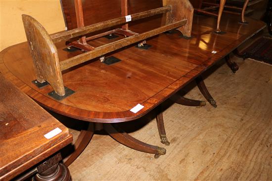 Regency style banded mahogany two pillar dining table, fitted 4 spare leaves